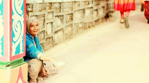 Female beggar begging on road