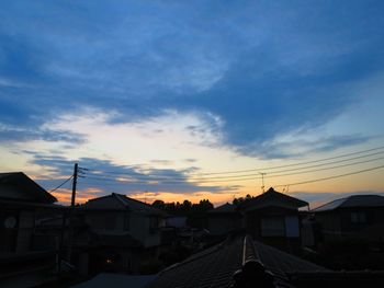 High angle view of houses against sky at sunset