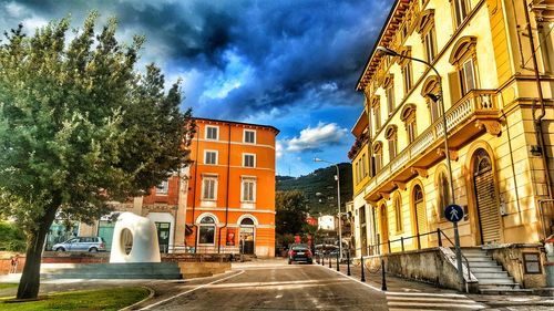 Street amidst buildings against sky in city