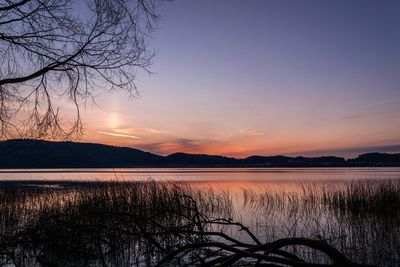 Scenic view of lake against sky during sunset