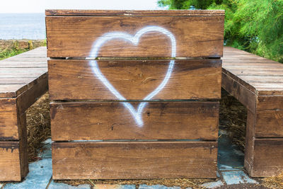 Heart shape on wood by lake