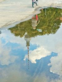 Reflection of clouds in puddle