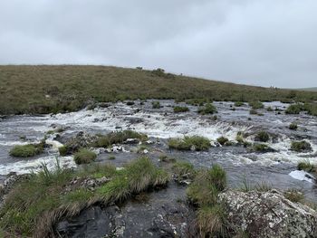 Scenic view of waterfall against sky