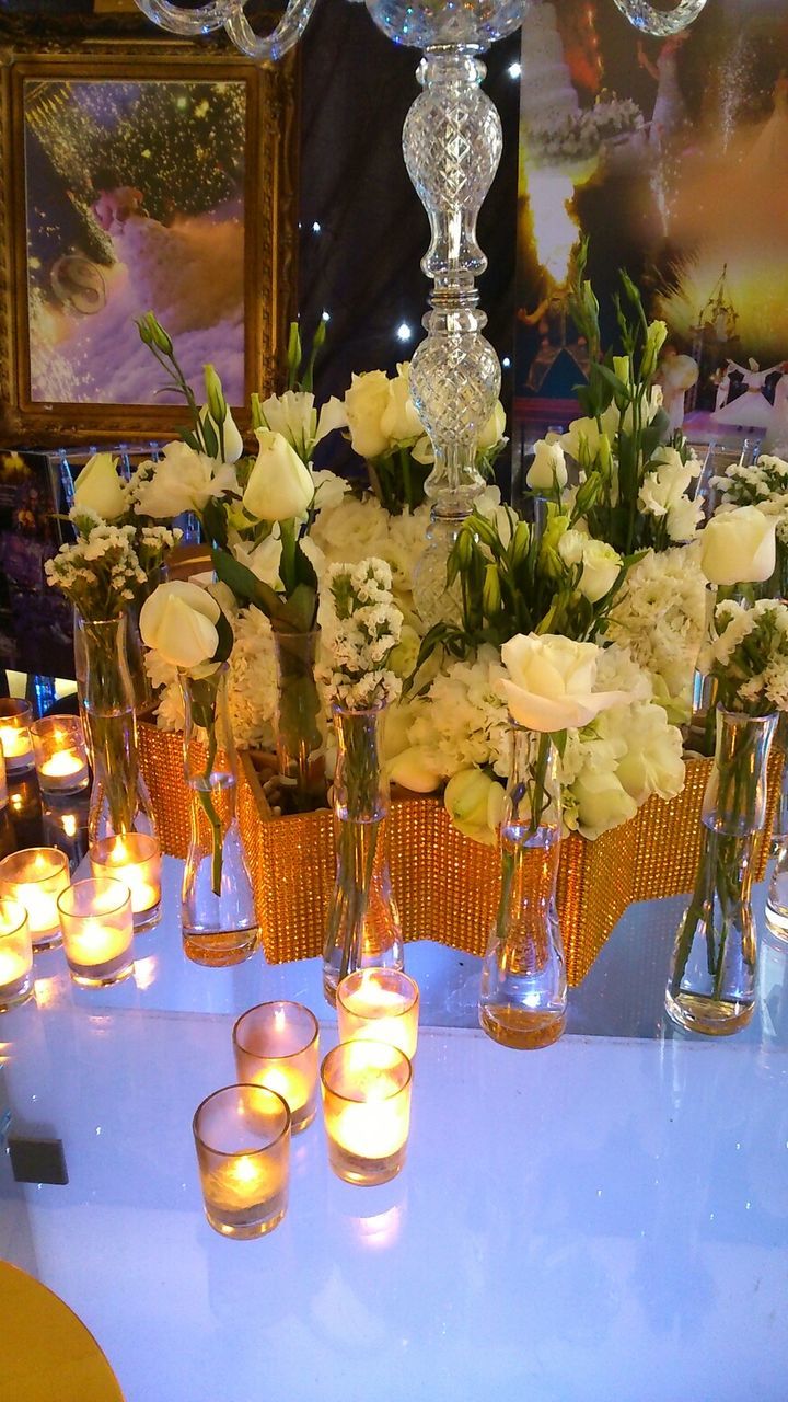 indoors, table, decoration, glass - material, illuminated, still life, wineglass, lighting equipment, variation, arrangement, vase, hanging, drinking glass, large group of objects, restaurant, transparent, reflection, celebration, in a row, candle