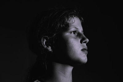 Girls looking away against black background