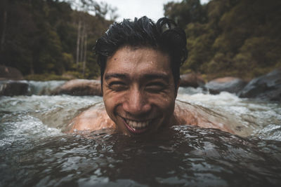 Close-up portrait of smiling man in stream