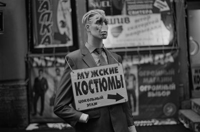 Mannequin with sign board at store