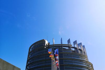 Low angle view of modern building against blue sky