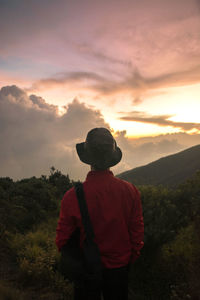 Rear view of man looking at sunset