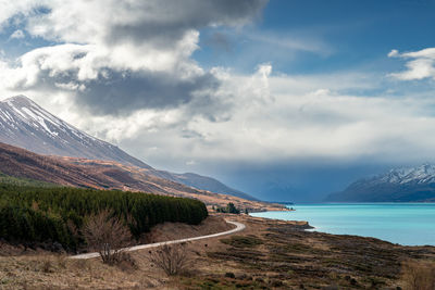 Mount cook road alongside lake pukaki with snow capped southern alps in winter evening light. 