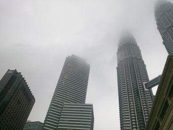 Low angle view of skyscrapers against sky in city