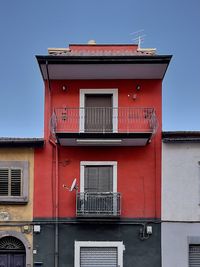 Low angle view of red building against clear sky