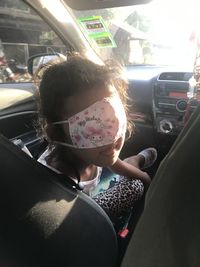 Portrait of woman sitting in car