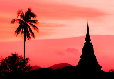 Silhouette of palm trees against sky during sunset