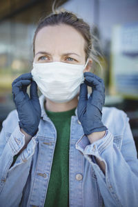 Portrait of young woman covering face