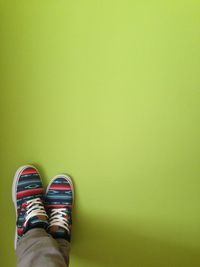 Low section of person standing on tiled floor