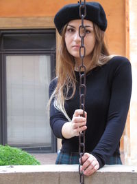 Portrait of young woman wearing hat