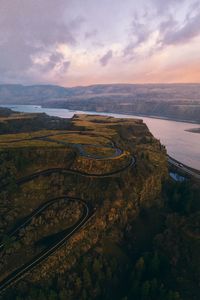 High angle view of cliff road against sky during sunrise