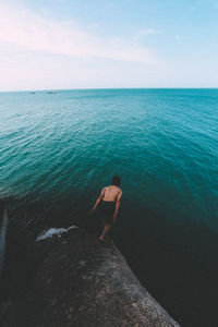 High angle view of man jumping in sea