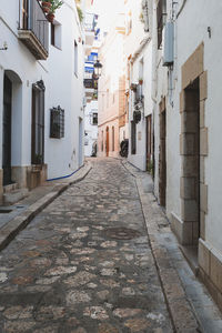 Narrow street amidst buildings in city