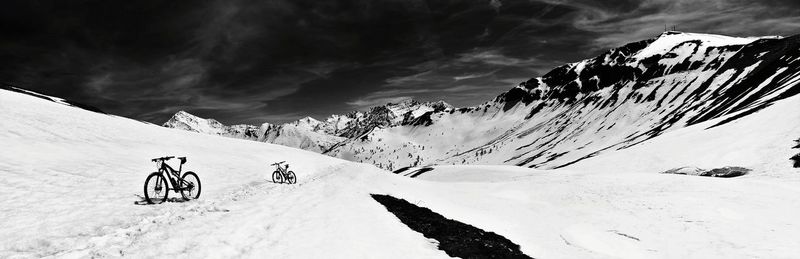 Scenic view of snow and mountains against sky