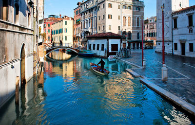 High angle view of man in boat sailing on river in city