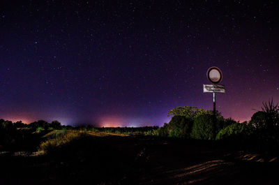 Low angle view of trees against sky at night