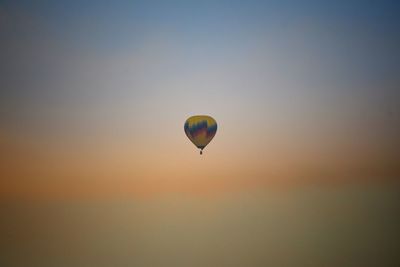 Hot air balloons against sky during sunset