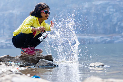 Side view of girl playing in water