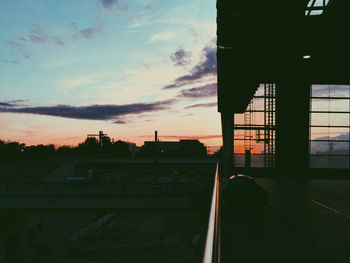 Silhouette city against sky during sunset