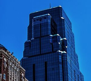 Low angle view of modern buildings against clear blue sky