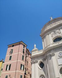 Low angle view of building against clear blue sky