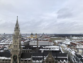 High angle view of buildings against cloudy sky