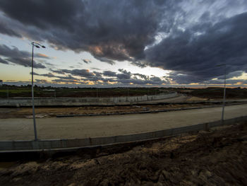 Scenic view of landscape against storm clouds