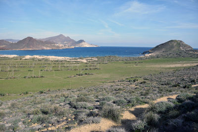 Scenic view of sea and mountains against sky