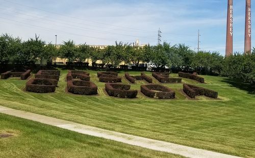 Stack of hay bales on field against sky