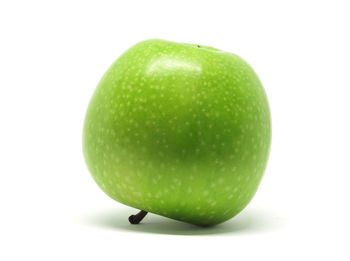 Close-up of green apple on background