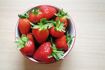 High angle view of strawberries in bowl on table