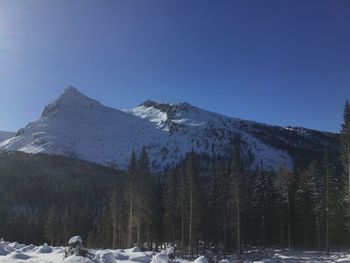 Scenic view of snowcapped mountains against clear sky