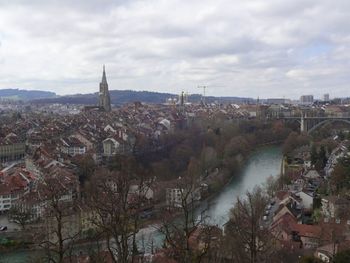 View of cityscape against cloudy sky