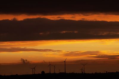 Scenic view of silhouette field against sky during sunset
