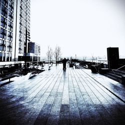 Buildings in city against clear sky