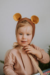 Toddler baby girl in funny hat with ears having fun