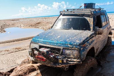 View of abandoned car on beach