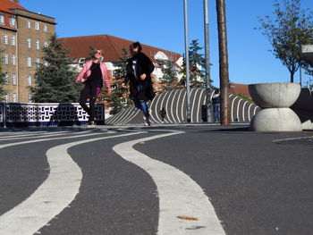 Man and woman running at superkilen park