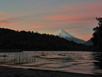 Scenic view of lake against sky at sunset