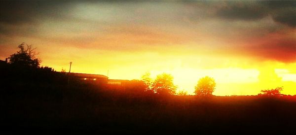 Scenic view of landscape against sky at sunset