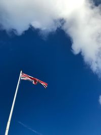 Low angle view of british flag against blue sky