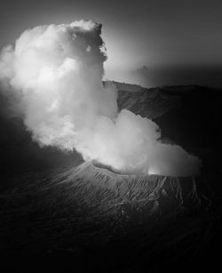 Smoke emitting from volcanic mountain against sky