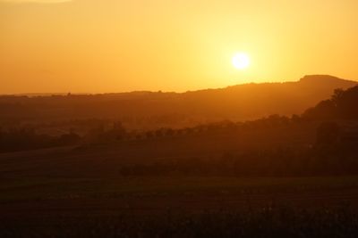 Scenic view of landscape against sky during sunset